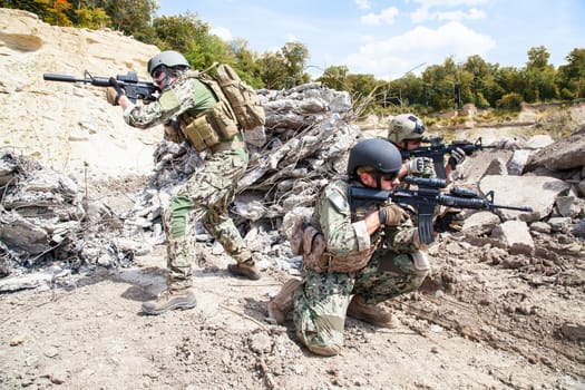 Members of Navy SEAL Team with weapons in action
