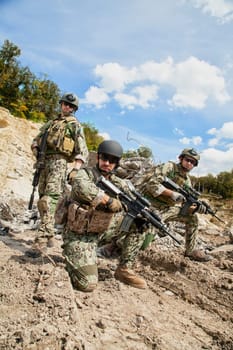 Members of Navy SEAL Team with weapons in action