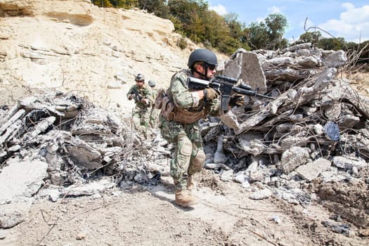Members of Navy SEAL Team with weapons in action