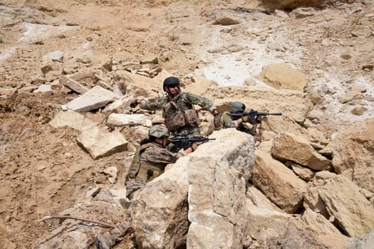 Members of Navy SEAL Team with weapons in action