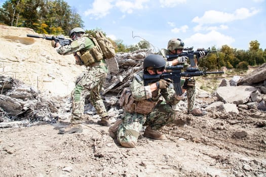 Members of Navy SEAL Team with weapons in action