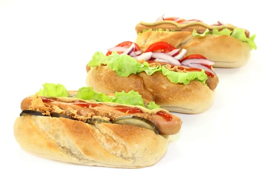 a hot dog with cucumber and salad against a white background