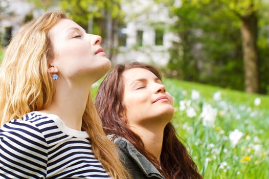 Two young women enjoy the spring sun