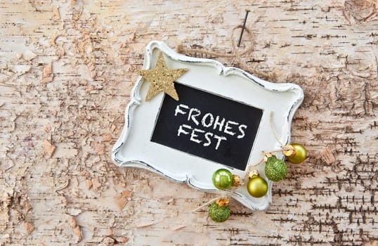 Table with vintage frame on rustic bark
