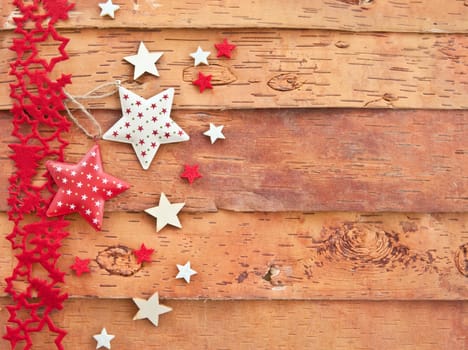 Rustic wooden background with colorful stars for Christmas