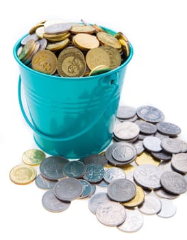 a full bucket of coins on white background