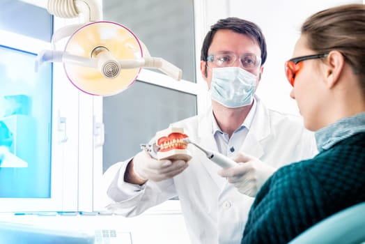 young attractive dentist in consulting