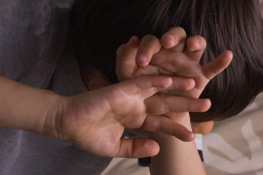 Child raising hands to protect itself