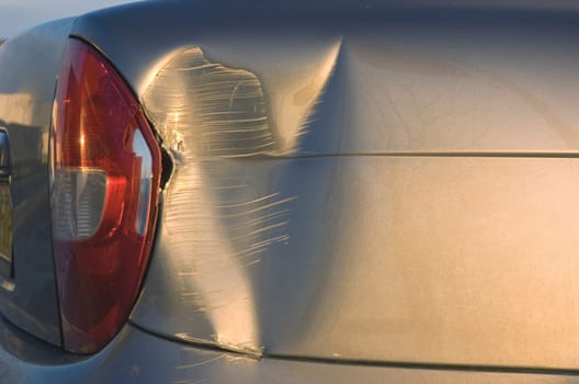 A dent in the right front quarter of a european car