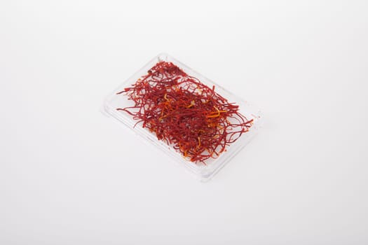Little plastic box of spanish Saffron Isolated on white background