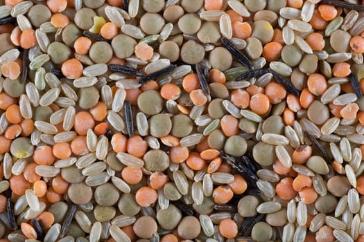 Red and green lentils with brown and wild rice, food background.