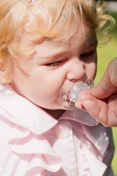 Image of cute baby girl suckle nipple