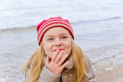 Beautiful Red Hat smiling girl on riverside