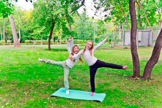 Photo of two playing girls in summer