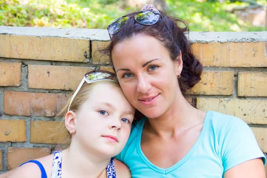 Photo of mother and daughter in summer with sunglass