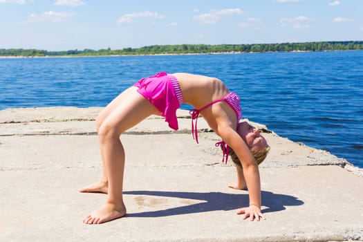 Photo of girl practices yoga in pose footbridge