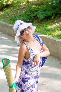 Cute girl in summer dress and white hat