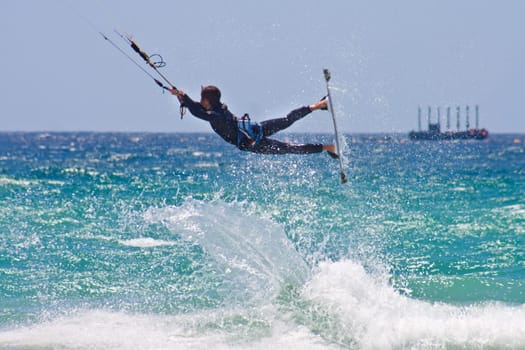 Unidentified sportsman kite surfer jumping in Tarifa, Spain