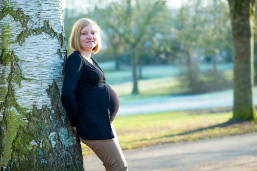 young blond pregnant woman alone the park