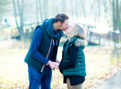 young pregnant woman with her husband in the park