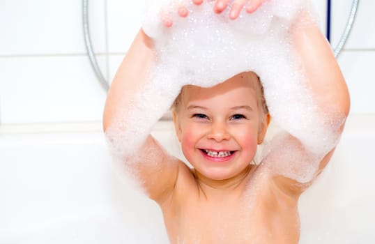 little funny girl with foam bathtub in the bathtub