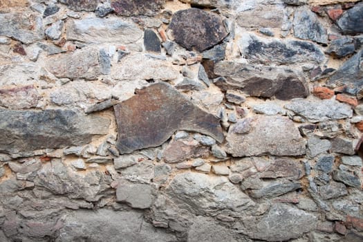 Natural stone wall with very different sized stones.