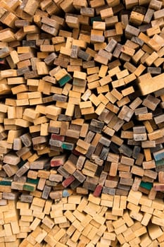 Trimmed and debarked timber planks piled up at a sawmill