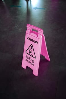 Caution sign for warning, falling in love, on a floor