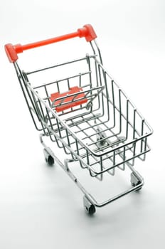 Empty shopping cart, side view, on white background