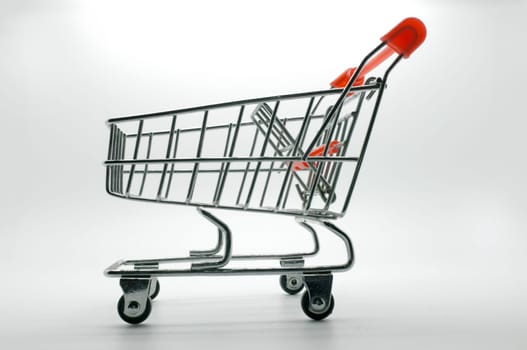 Empty shopping cart, side view, on white background