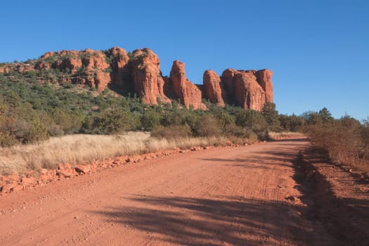 Dirt road through the red desert of Sedona, Arizona through Red Rocks.