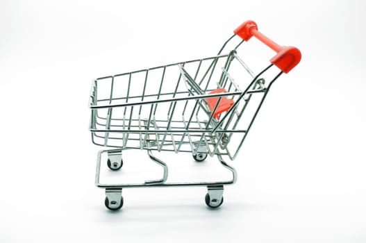 Empty shopping cart, side view, on white background