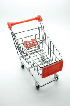 Empty shopping cart, side view, on white background