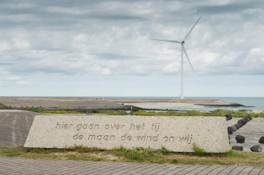 Dutch phrase on a stone on the artificial island Neeltje Jans in Zeeland, Netherlands. It says