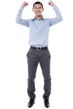 Happy young male with his arms up in victory gesture