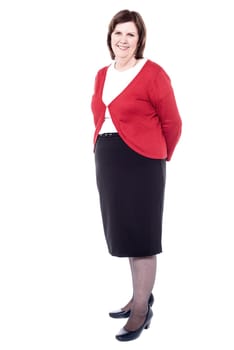 Senior woman posing to camera while supervising her team