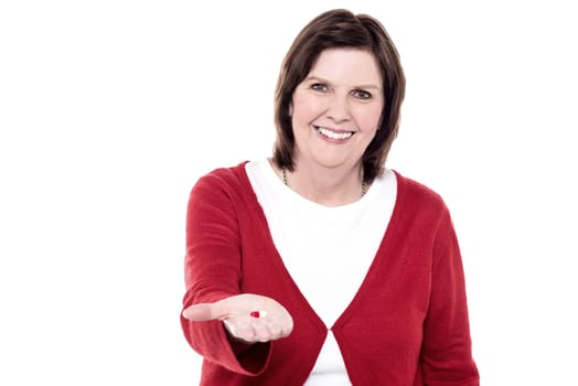 Senior woman lending something to you