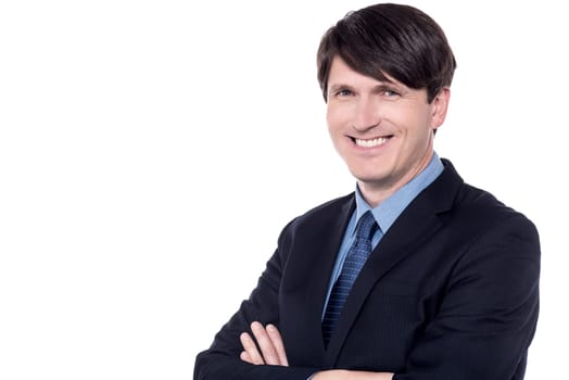 Confident male executive posing with folded arms