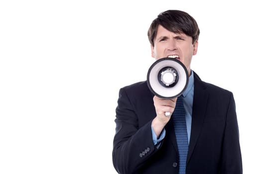 Businessman screaming on a megaphone, isolated over white