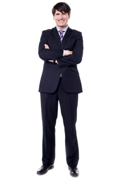 Confident businessman with crossed arms over white