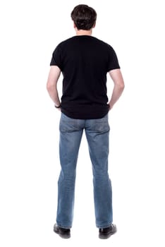 Back view of casual man, facing the wall