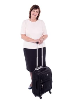 Old woman posing stylishly with strolley bag