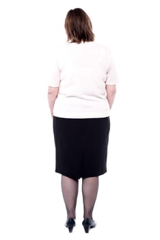 Back pose of a senior woman facing the wall
