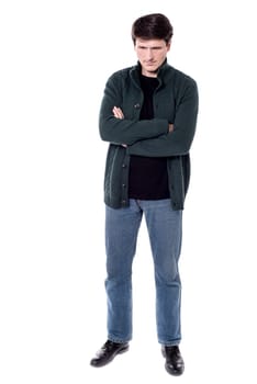 Man looking down with folded arms over white