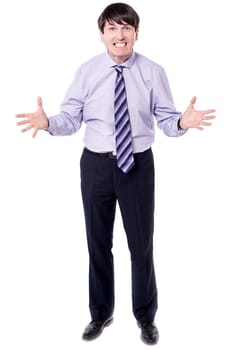 Irritated businessman with open arms against white background