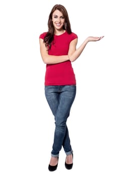 Young woman posing open palm, copy space concept