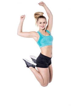 Charming young lady jumping high in the air