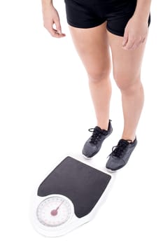 Lady about to measure her weight, cropped image.