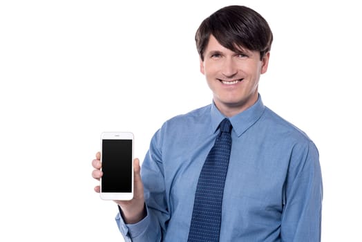 Happy executive showing his mobile phone to camera