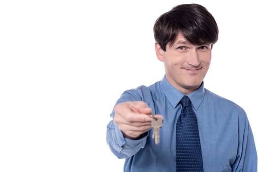 Smart executive offering house key over white